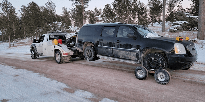 LJ's Recovery and Transport towing a large SUV near Custer, South Dakota.