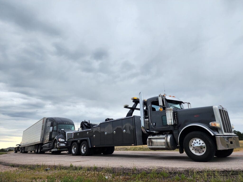 Semi Truck on Back of LJ's Recovery Towing Truck using Heavy Towing Equipment